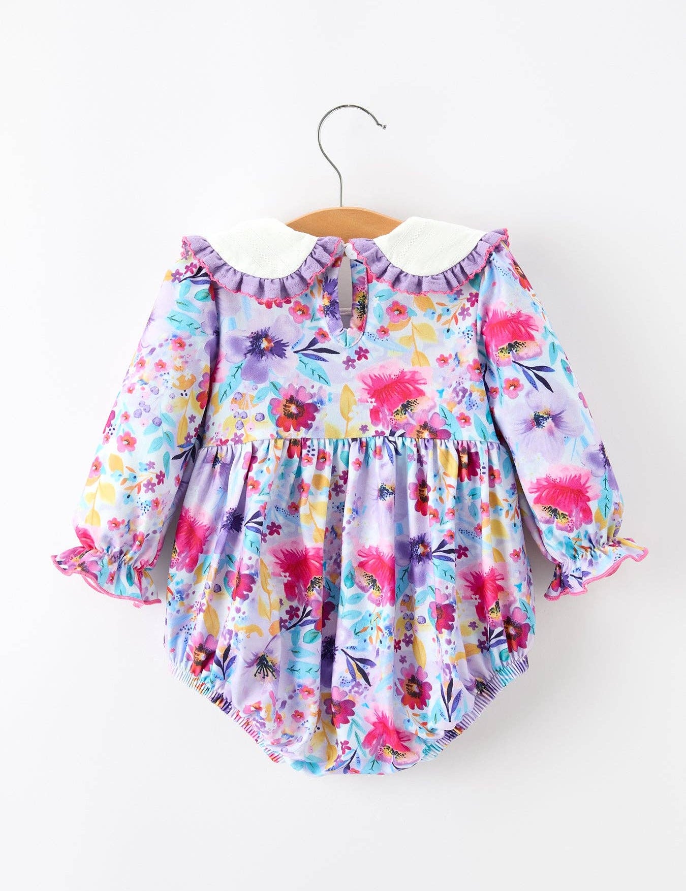Purple Floral Baby Girls Bubble Romper showing sweet bubble silhouette