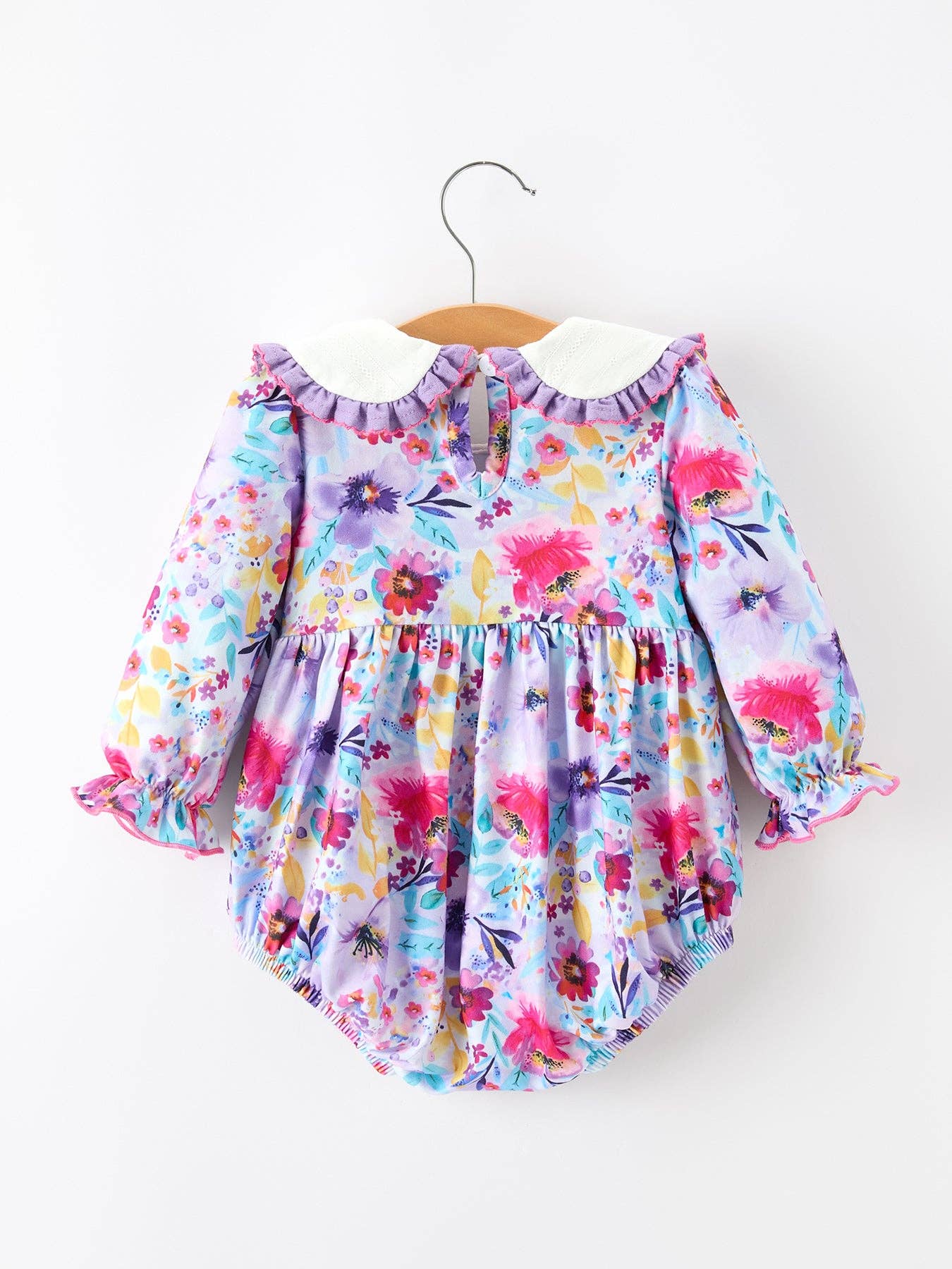 Purple Floral Baby Girls Bubble Romper showing sweet bubble silhouette