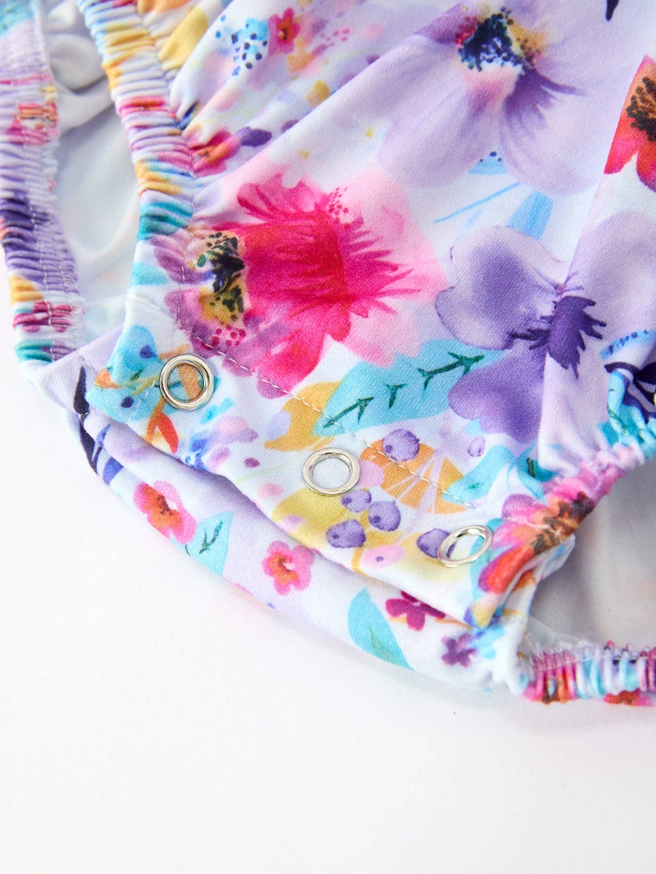 Purple Floral Baby Girls Bubble Romper showing ruffle collar