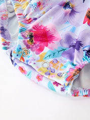 Purple Floral Baby Girls Bubble Romper showing ruffle collar