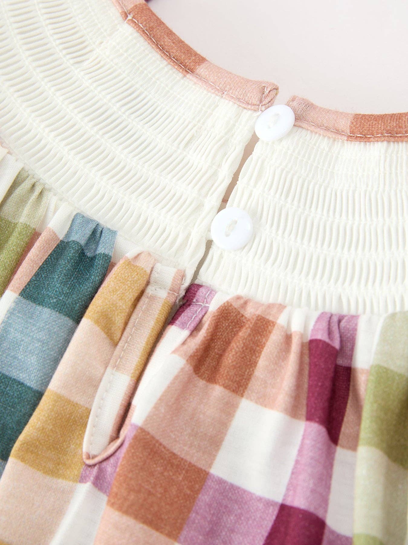 THANKFUL Smocked Plaid Bubble Romper showing ruffled bubble silhouette