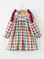 THANKFUL Smocked Plaid Dress — oversized bow shoulder straps and long puff sleeves