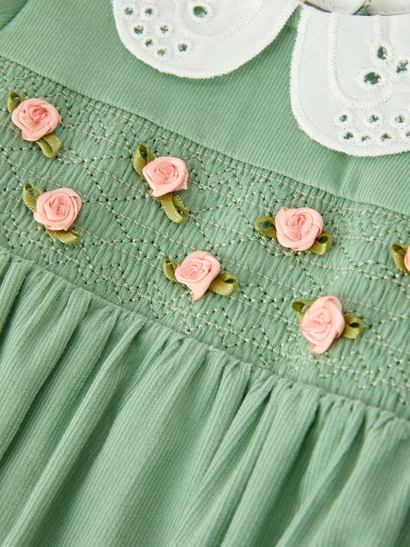 Green Smocked Floral Romper showing long puff sleeves