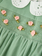 Green Smocked Floral Romper showing long puff sleeves