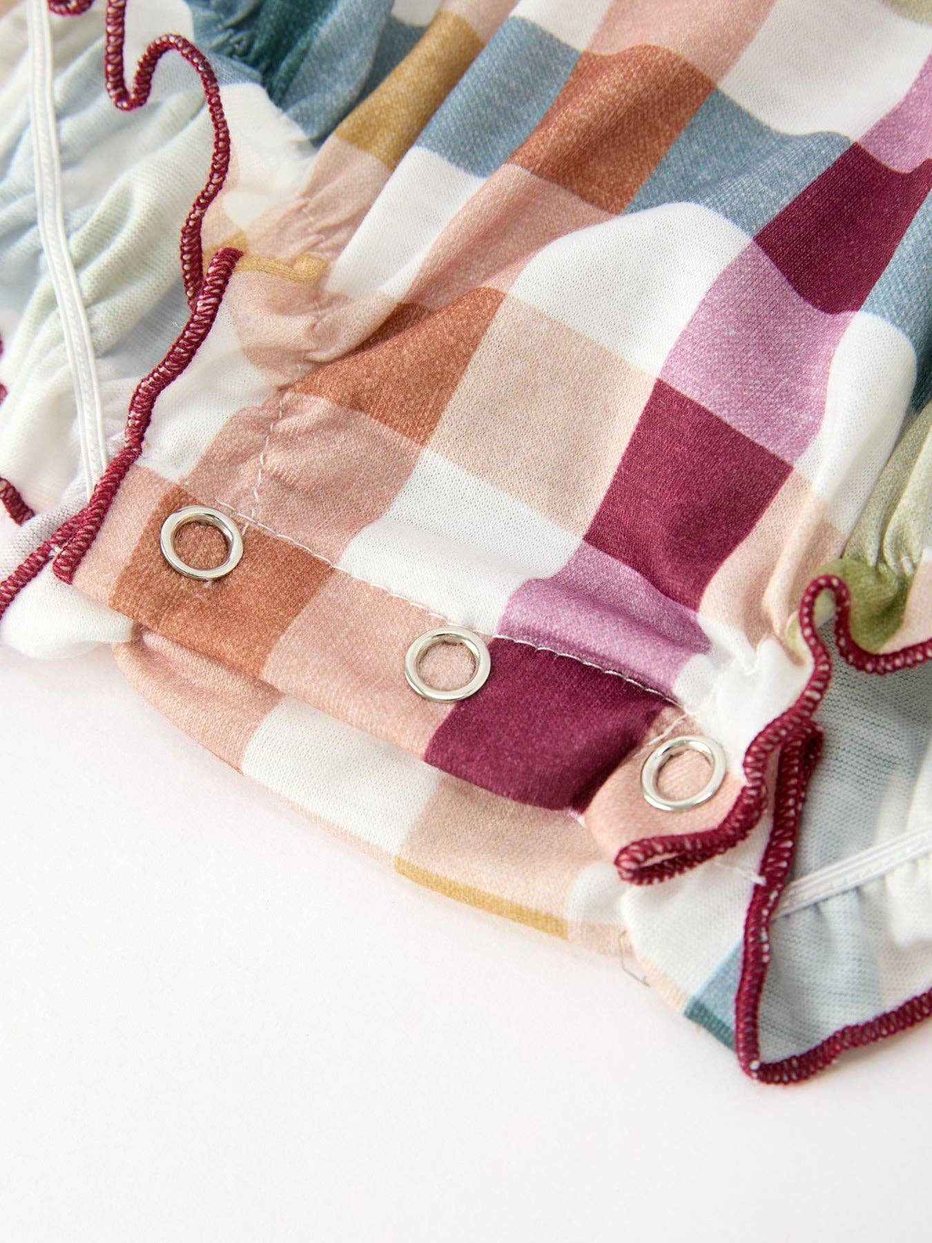 THANKFUL Smocked Plaid Bubble Romper showing soft plaid pattern