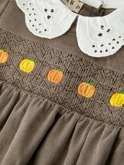 Pumpkin Smocked Eyelet Collar Romper showing white eyelet peter pan collar