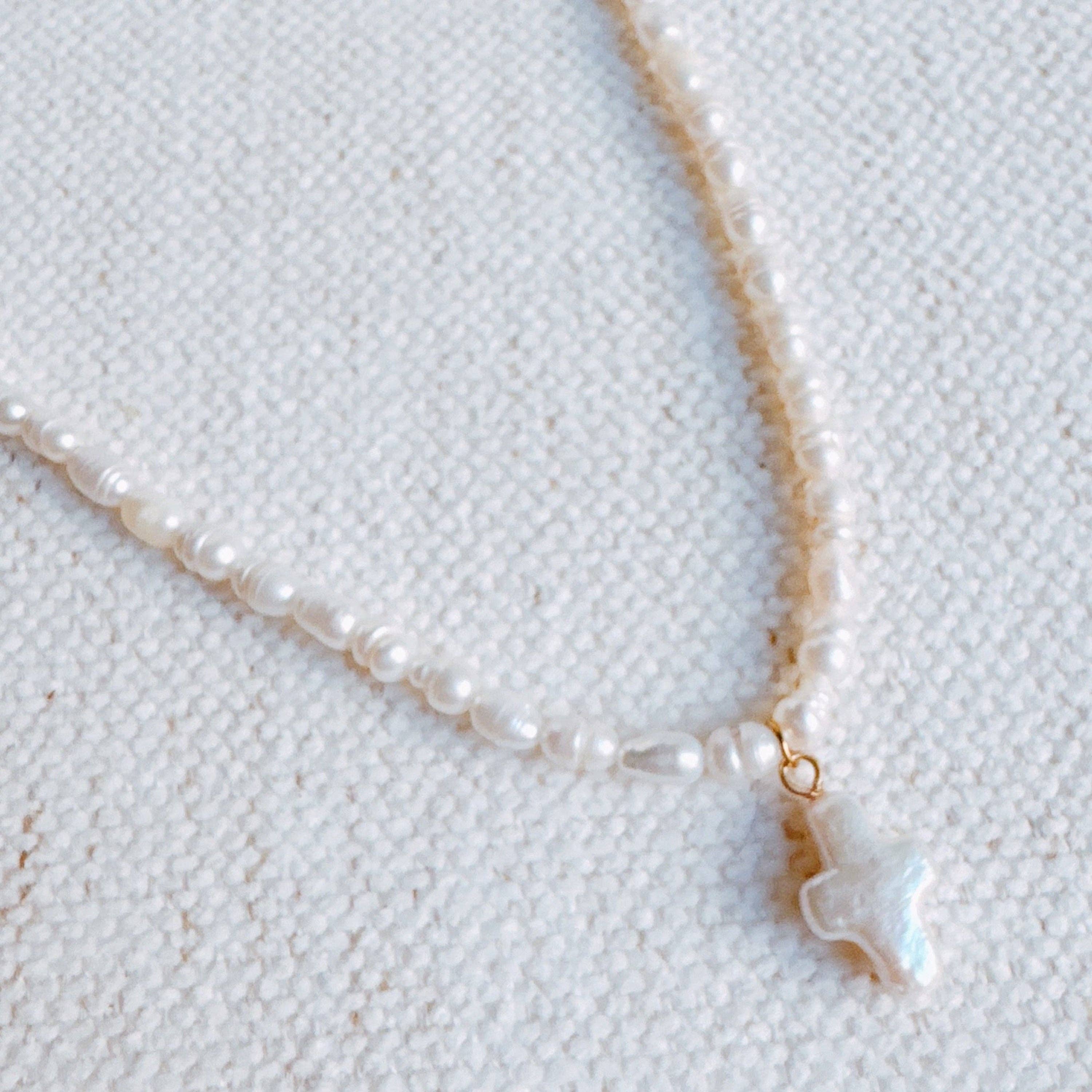 Genuine Freshwater Pearl Cross Necklace showing color: ivory white pearls with gold-tone findings