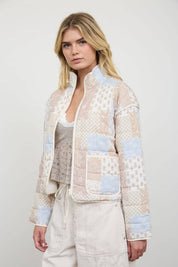 Cream Patchwork Quilted Jacket showing zipper closure on the front