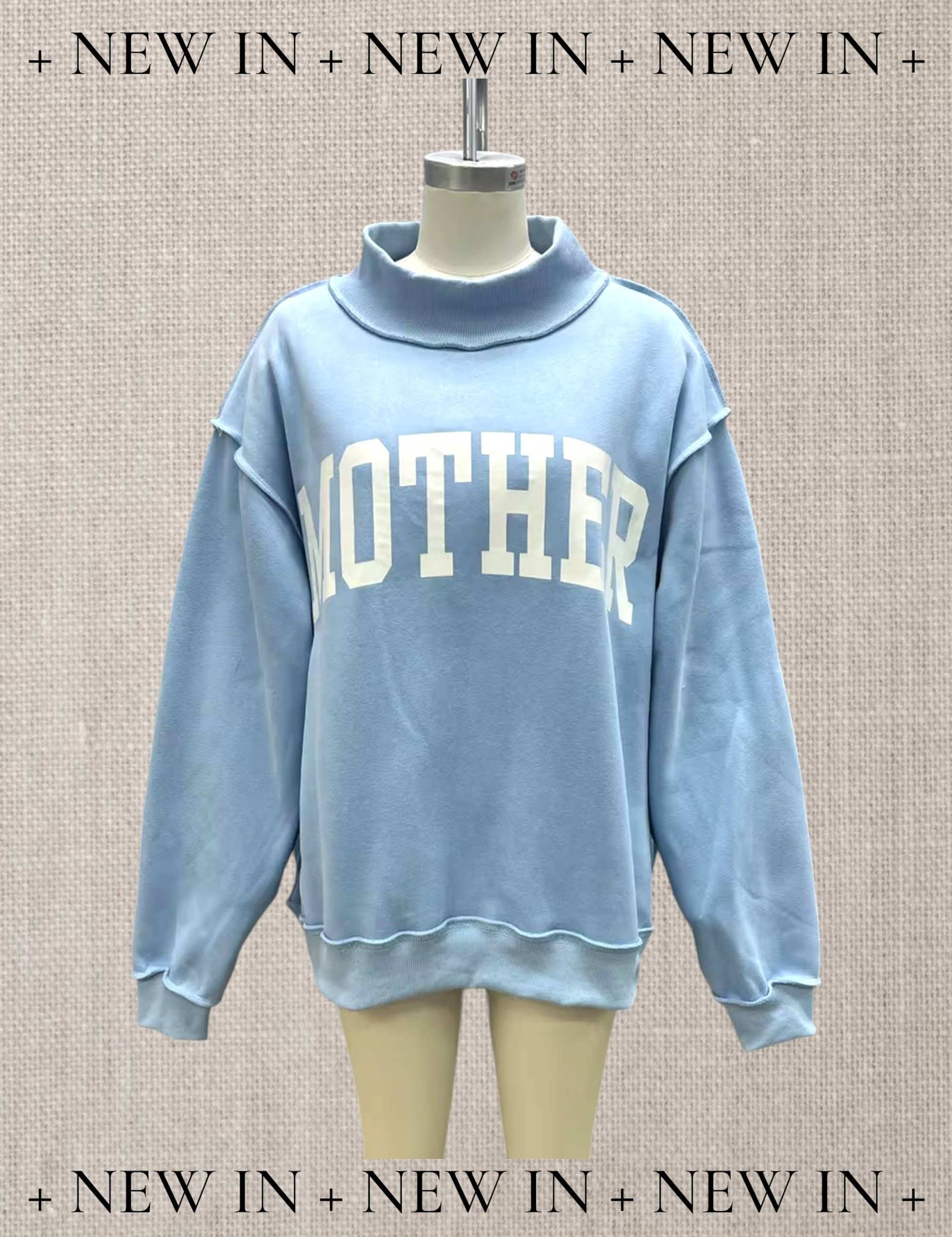 Blue Mother Reversible Mock Neck — color: light blue with white lettering and mock neckline