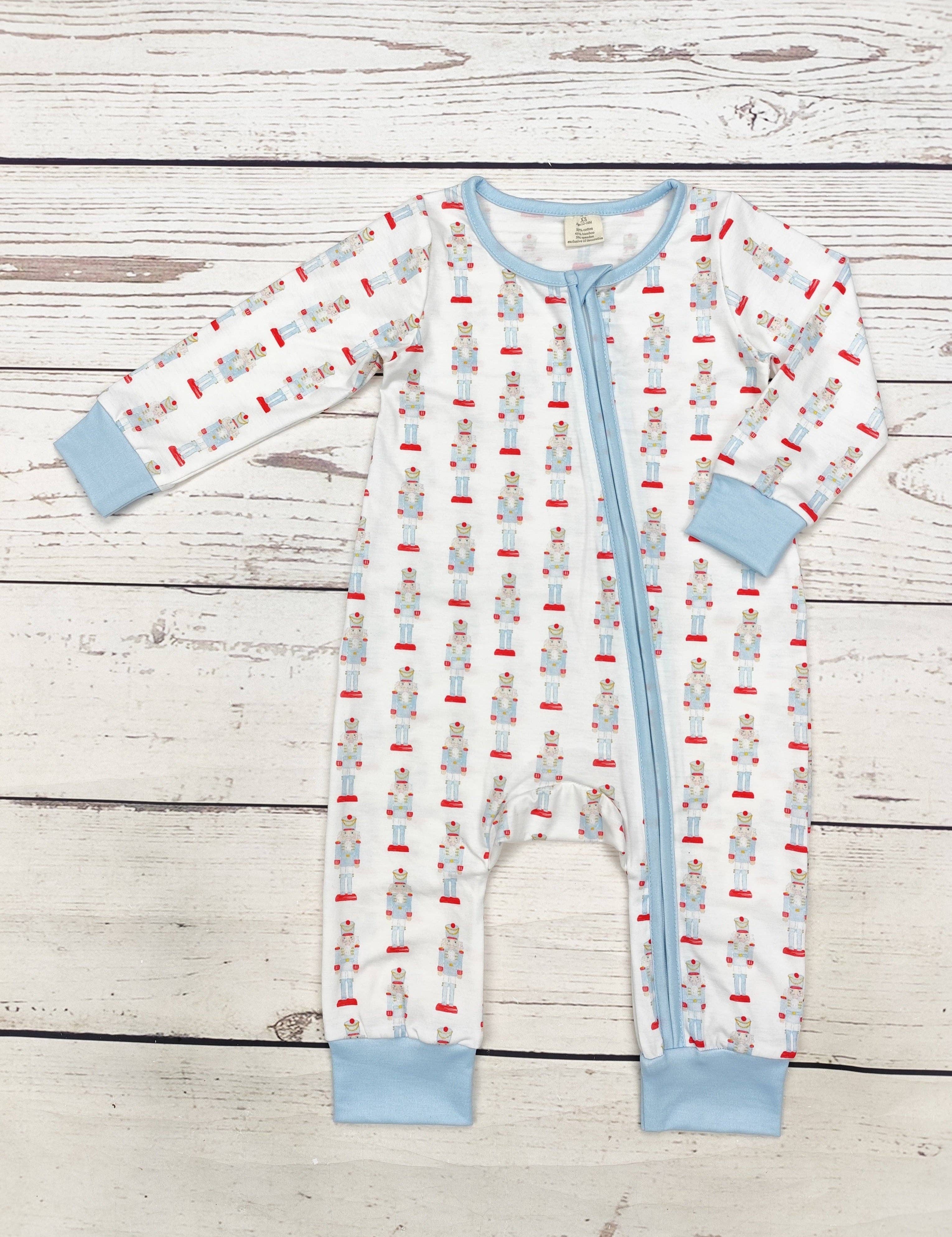 Baby Boy Christmas Zippy Sleeper — color: white with red and blue nutcracker print and crew neckline