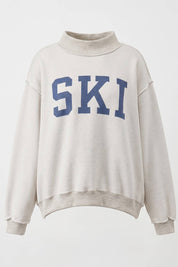APRES/SKI Reversible MockNeck showing color: cream with blue graphics
