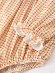 Orange Plaid Floral Bubble Romper showing ruffled cuffs