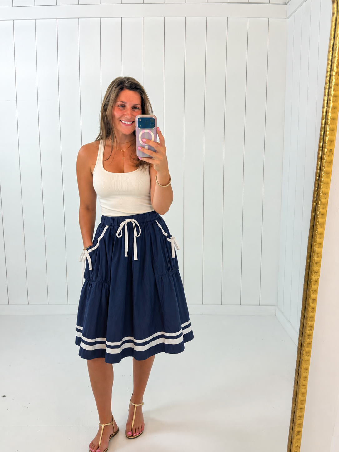 AI-styled Navy Front Tie Button Down Flare Midi Skirt with casual flat sandals