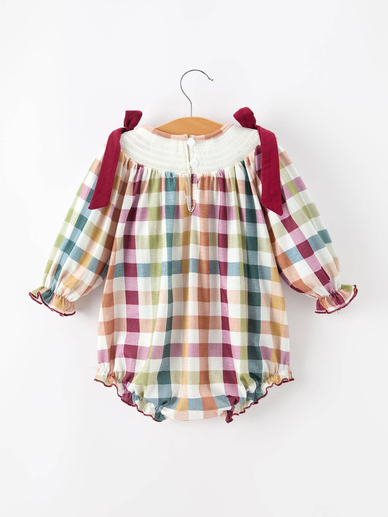THANKFUL Smocked Plaid Bubble Romper showing oversized bow shoulder straps
