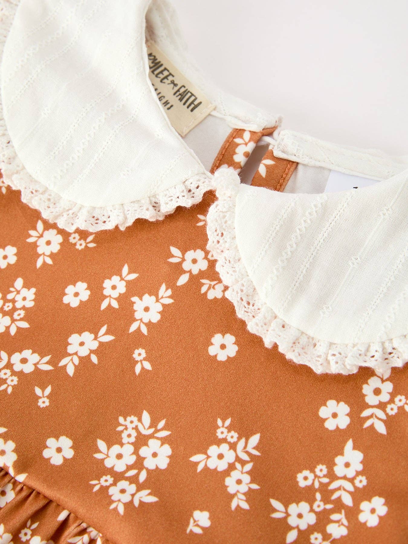 Rust Floral Bubble Romper showing shoulder ruffles