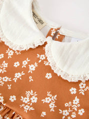 Rust Floral Bubble Romper showing shoulder ruffles