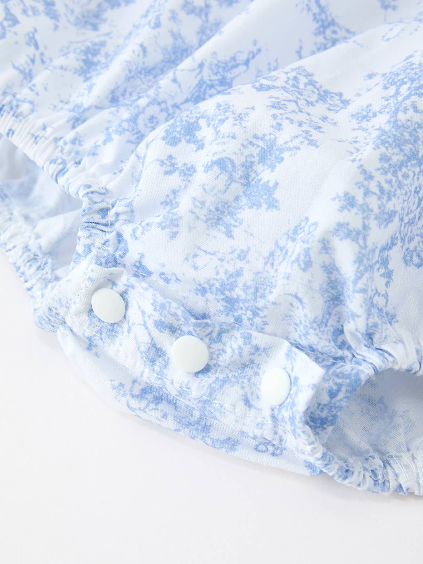 Blue Floral Smocked Matching Set Baby Romper showing ruffled neckline