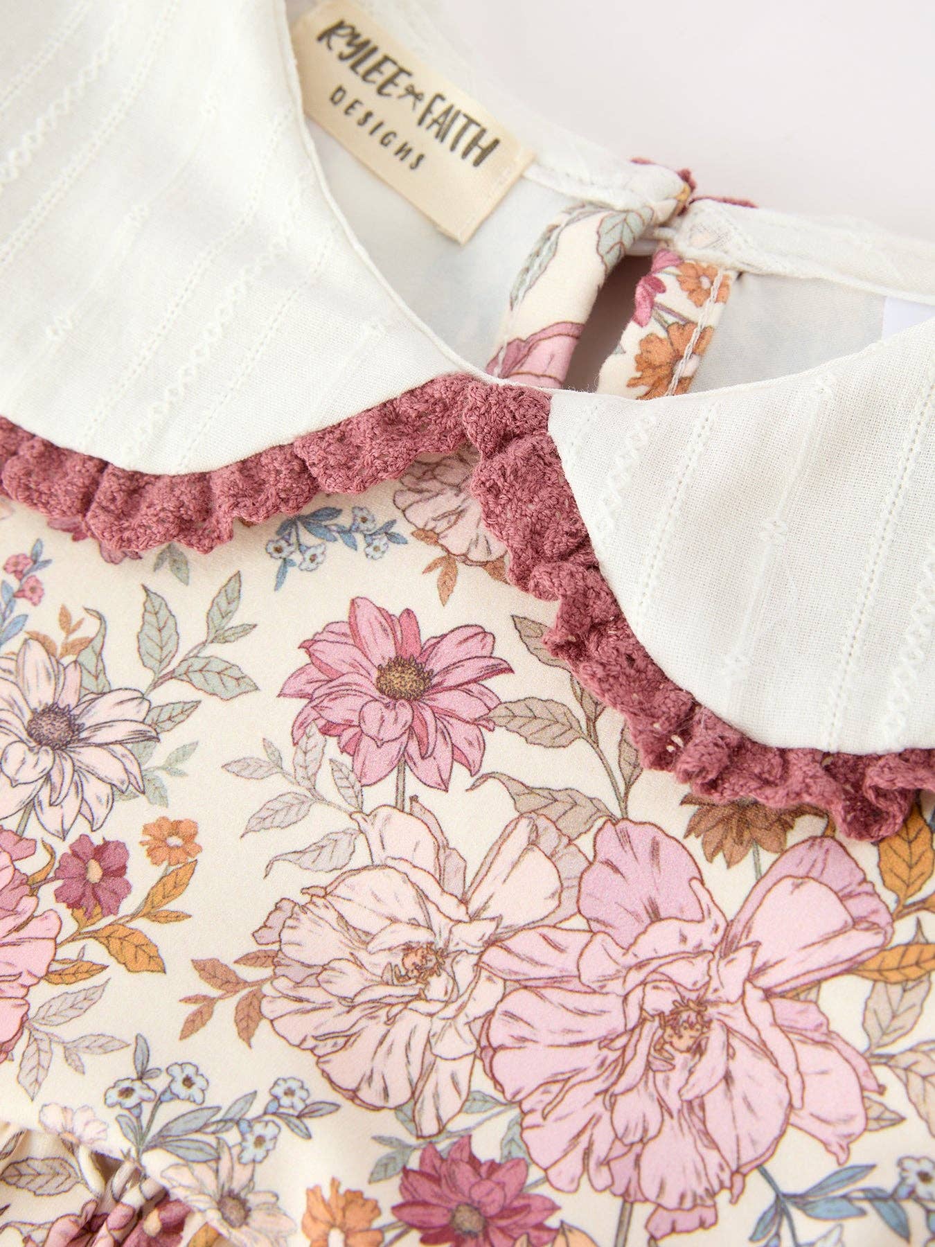 Fall Floral Bubble Romper showing shoulder ruffles