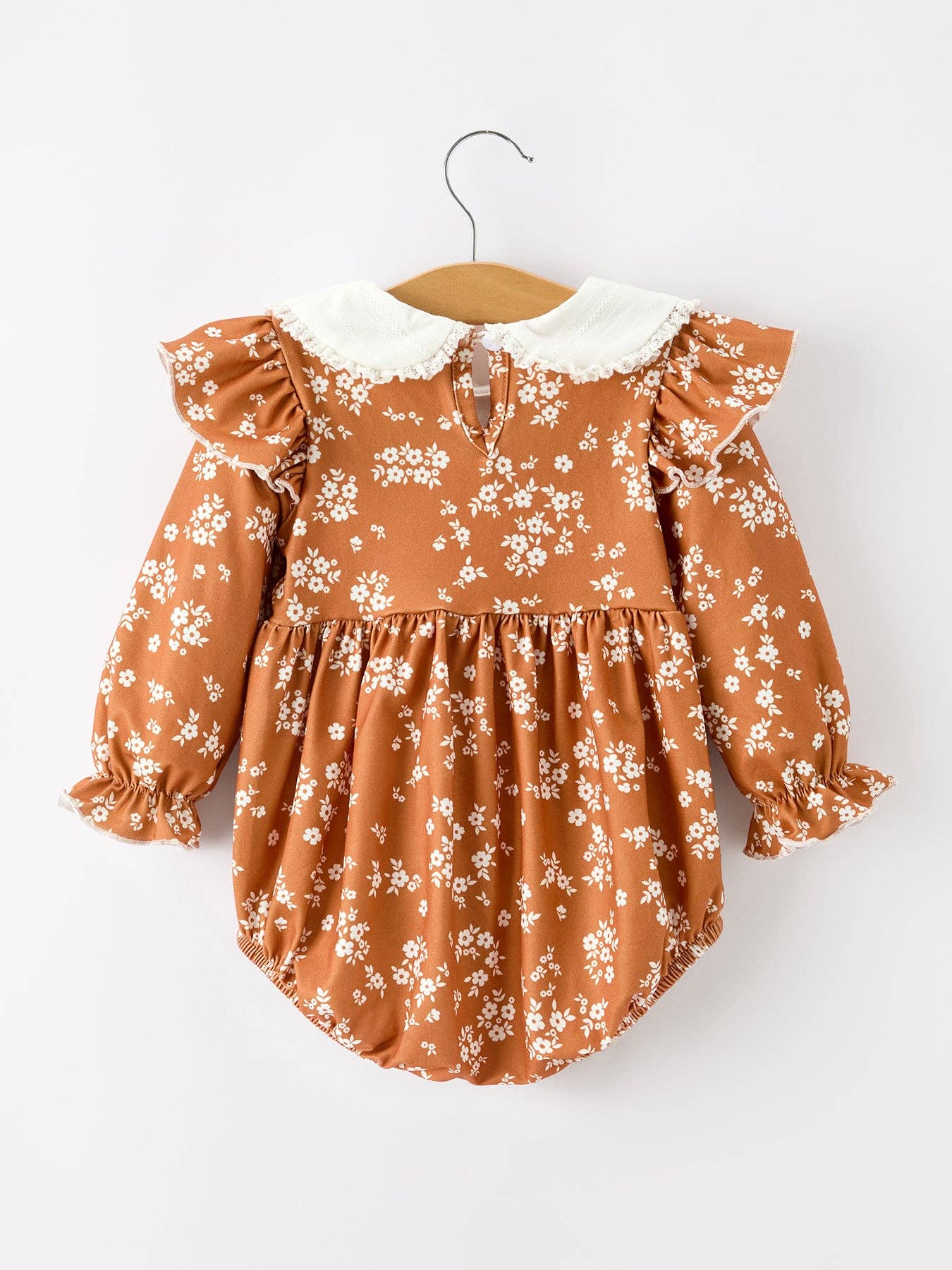 Rust Floral Bubble Romper showing dainty lace trim