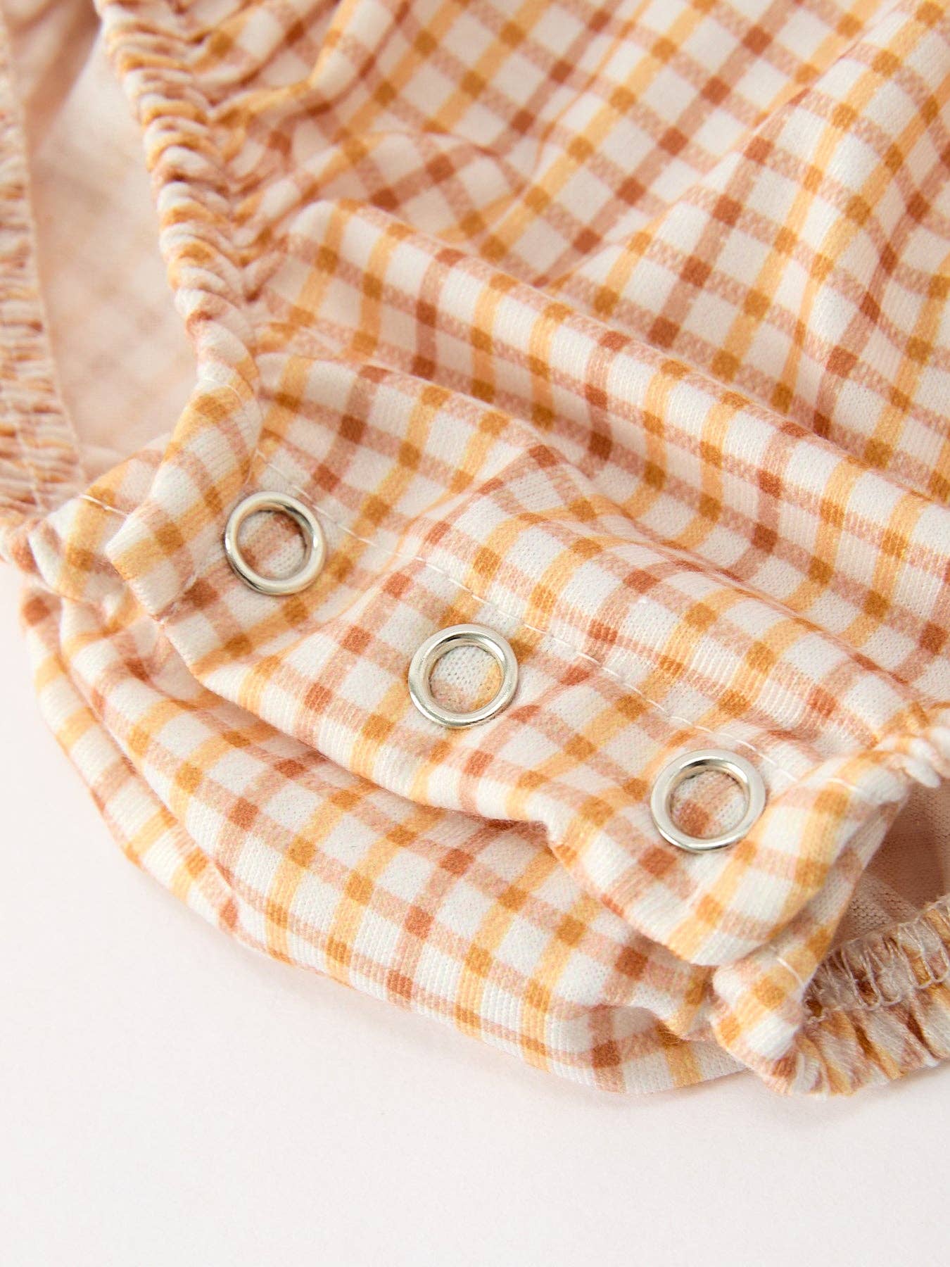 Orange Plaid Floral Bubble Romper showing gathered detailing