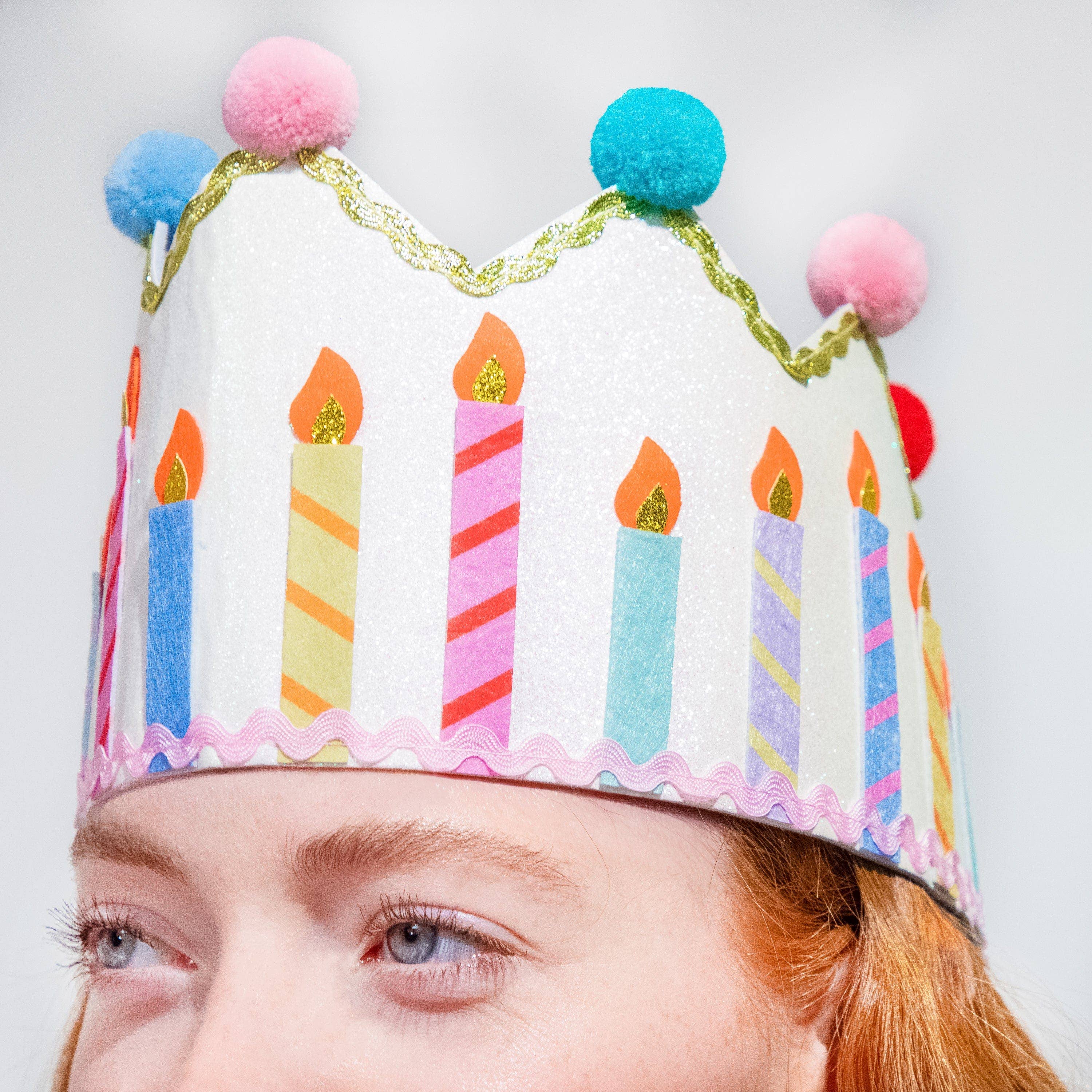 Birthday Wishes Reusable Birthday Crown showing glitter felt birthday crown with multicolor pom poms