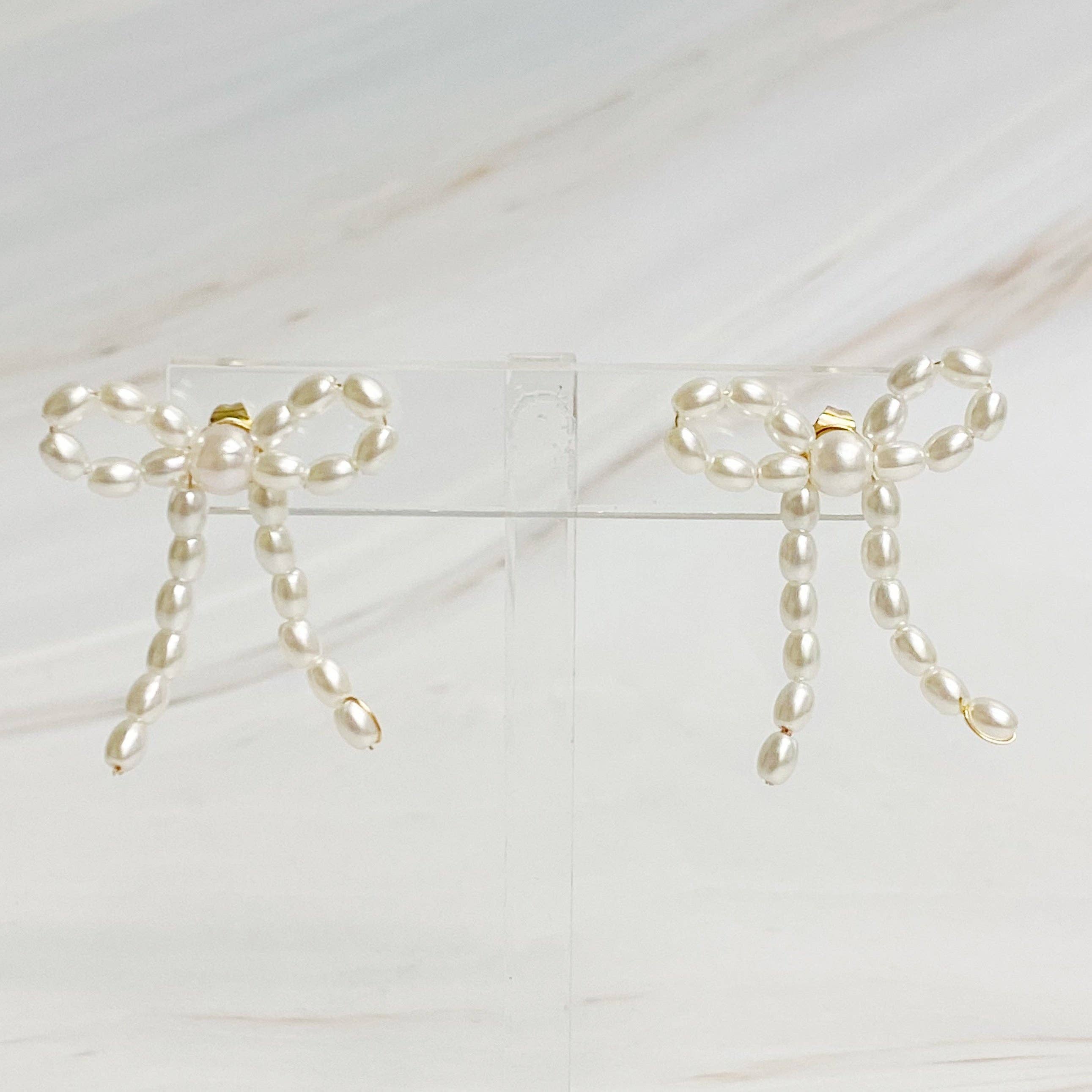 Pearl Bow Ballerina Earrings showing color: cream white pearls with gold-tone posts
