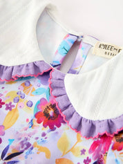 Purple Floral Baby Girls Bubble Romper showing snap buttons