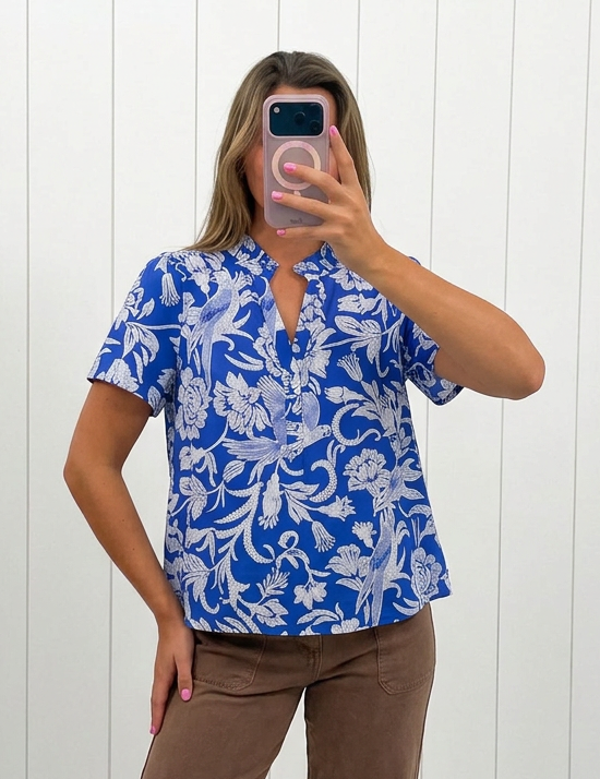 AI-assisted FASHN try-on of Blue Floral Split Neck Ruffle Top on boutique owner.