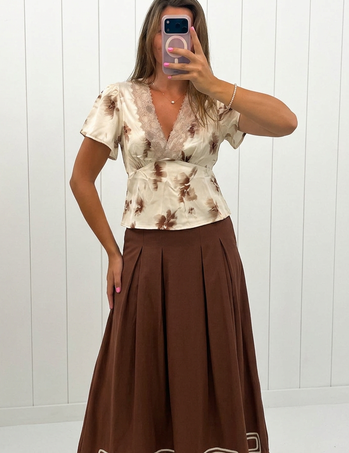 AI-assisted FASHN try-on of Brown Embroidered Pleated Maxi Skirt on boutique owner.