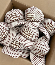 Led By Grace Cream & Brown Polka Dot Patch Hat — cream trucker hat with an allover brown polka dot print and brown rope