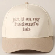 Beige Put It On My Husband's Tab Hat — “put it on my husband’s tab” across the front and embroidered detailing