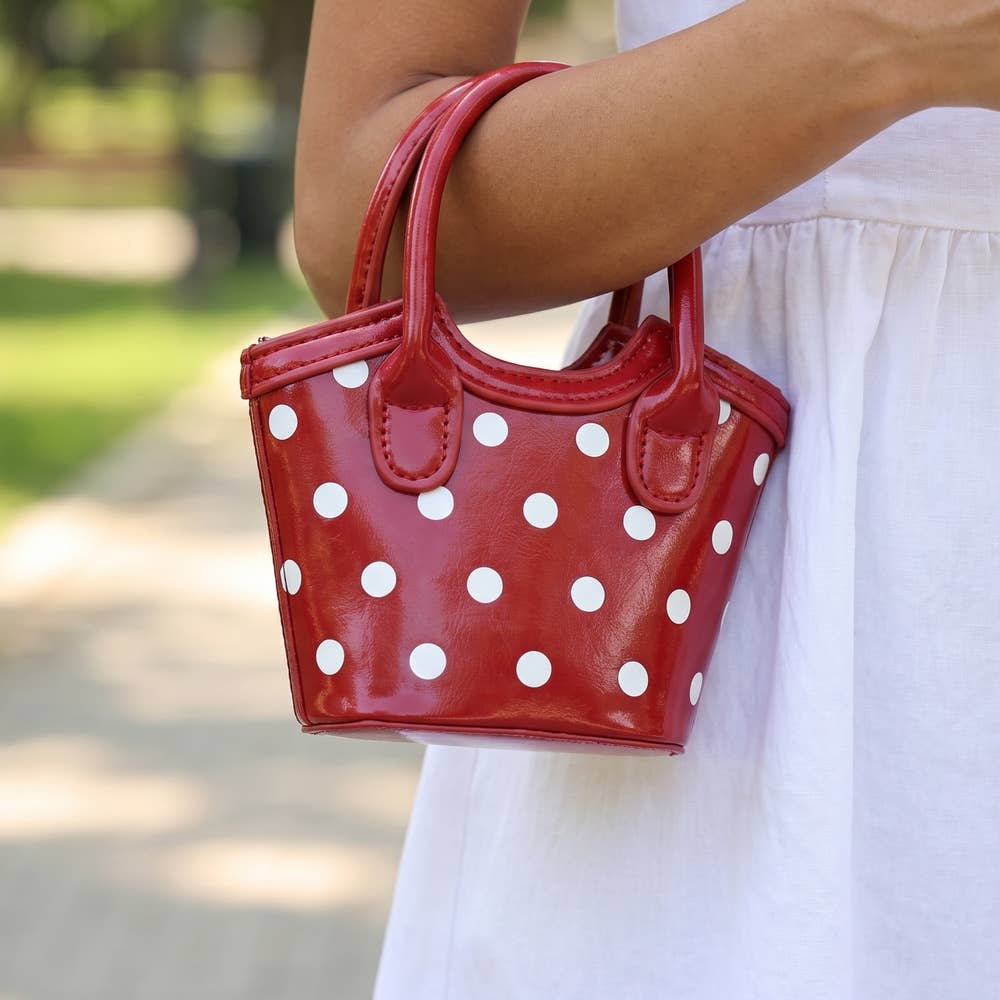Polka Dot Patent Mini Bucket Tote — mini bucket tote shape with dual rolled top handles and removable crossbody strap