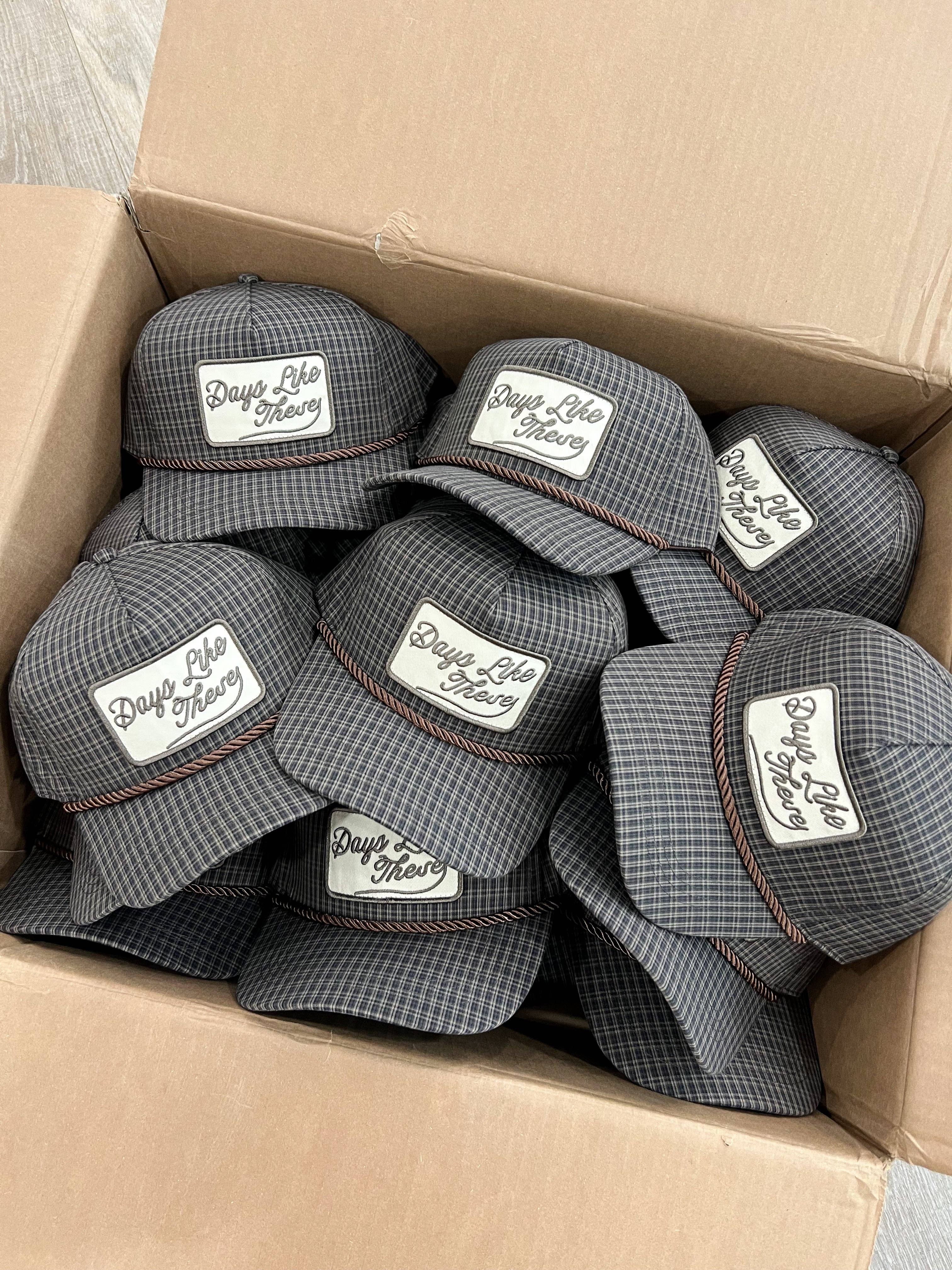 Days Like These Plaid Patch Hat Fall Hat — grey and navy plaid trucker hat and brown rope detail across the front