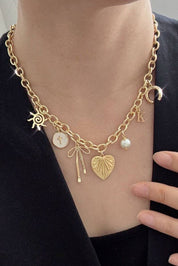 SUN BOW PEARL CROSS DISC U CHARM NECKLACE | 80N1182