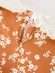 Rust Floral Bubble Romper showing bottom snaps