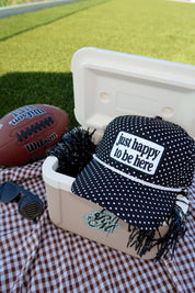 Just Happy To Be Here Polka Dot Patch Hat Game Day Hat showing black trucker hat with an allover white polka dot print