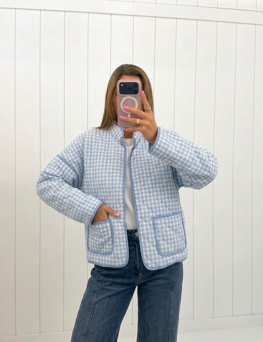 AI-assisted FASHN try-on of Light Blue Quilted Gingham Jacket on boutique owner.