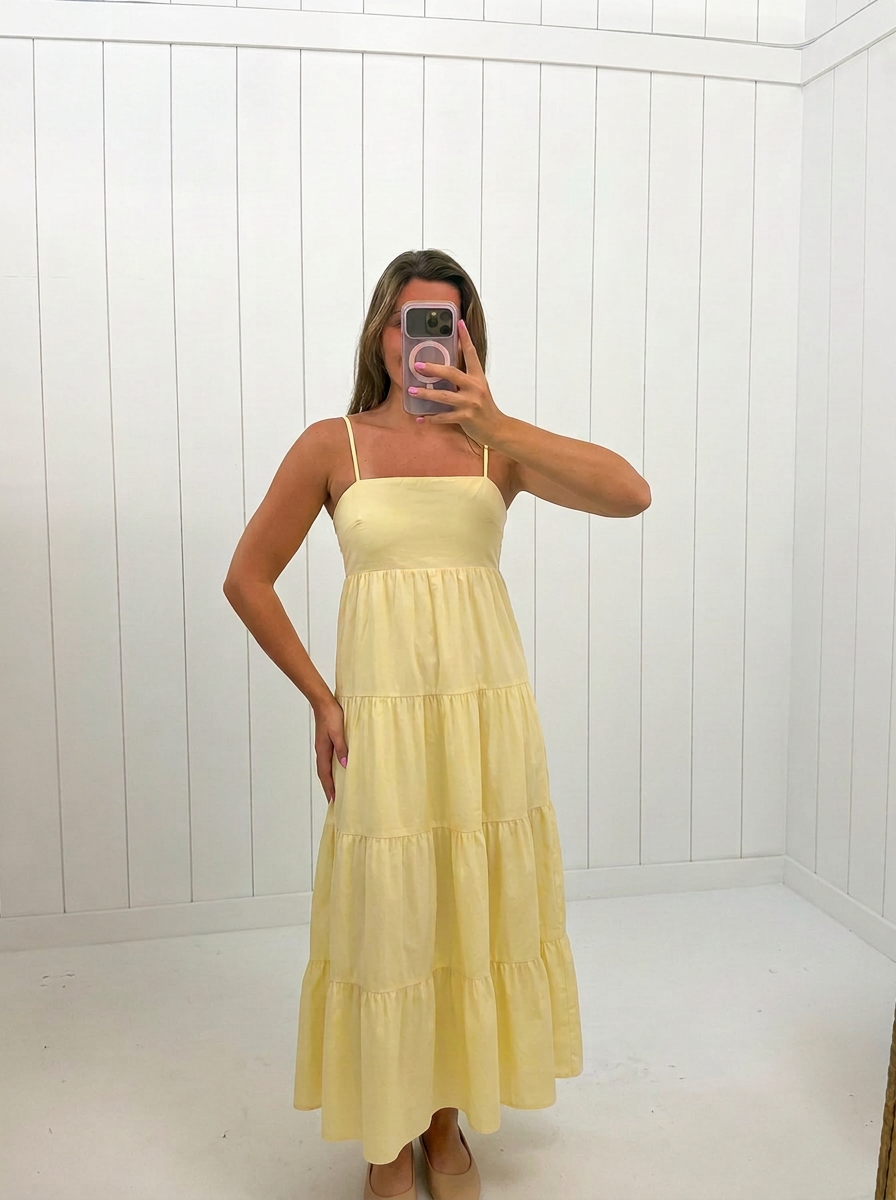 AI-assisted FASHN try-on of Yellow Iris Poplin Tiered Maxi Dress on boutique owner.