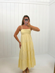 AI-assisted FASHN try-on of Yellow Iris Poplin Tiered Maxi Dress on boutique owner.