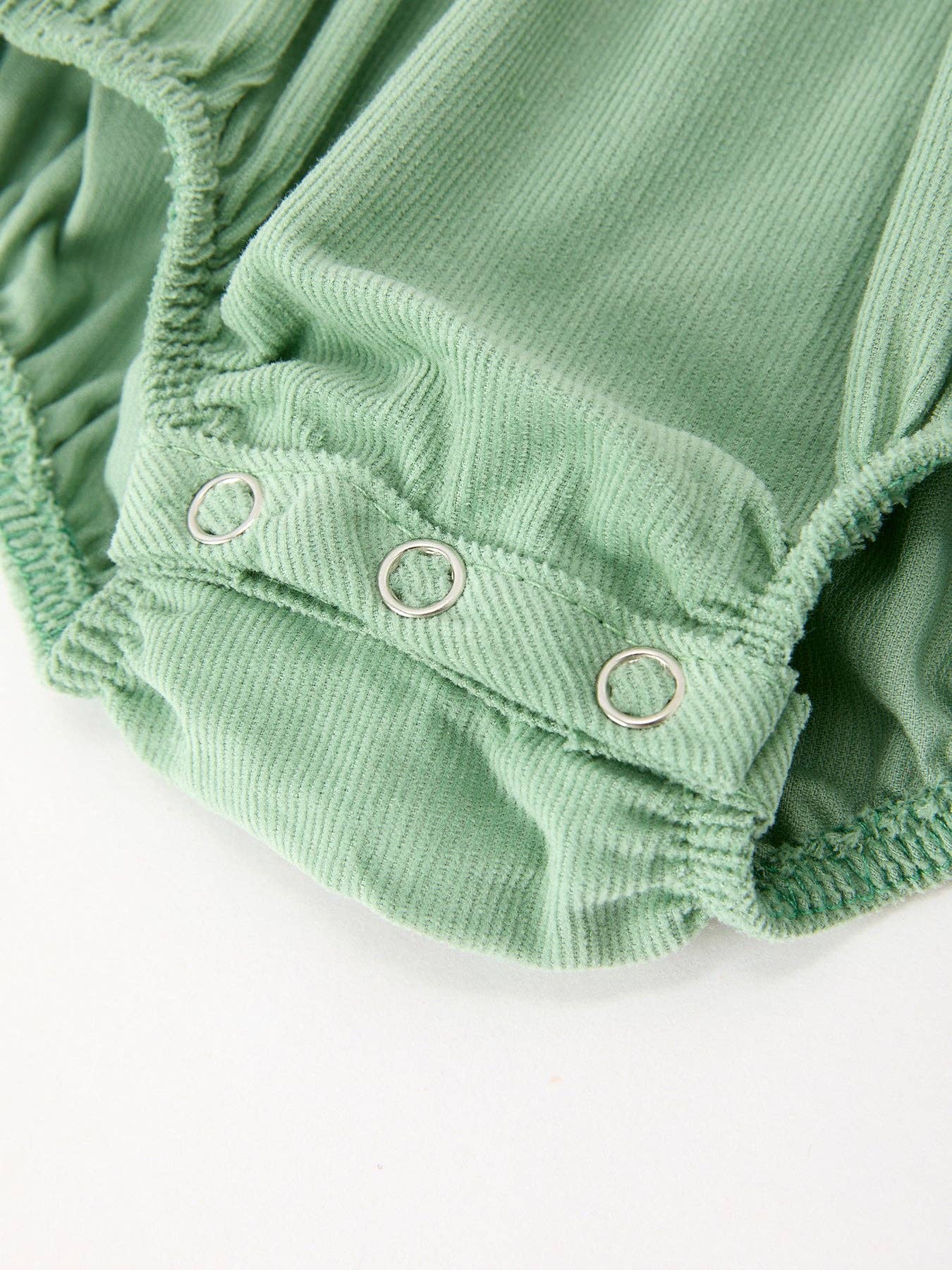 Green Smocked Floral Romper showing white eyelet peter pan collar
