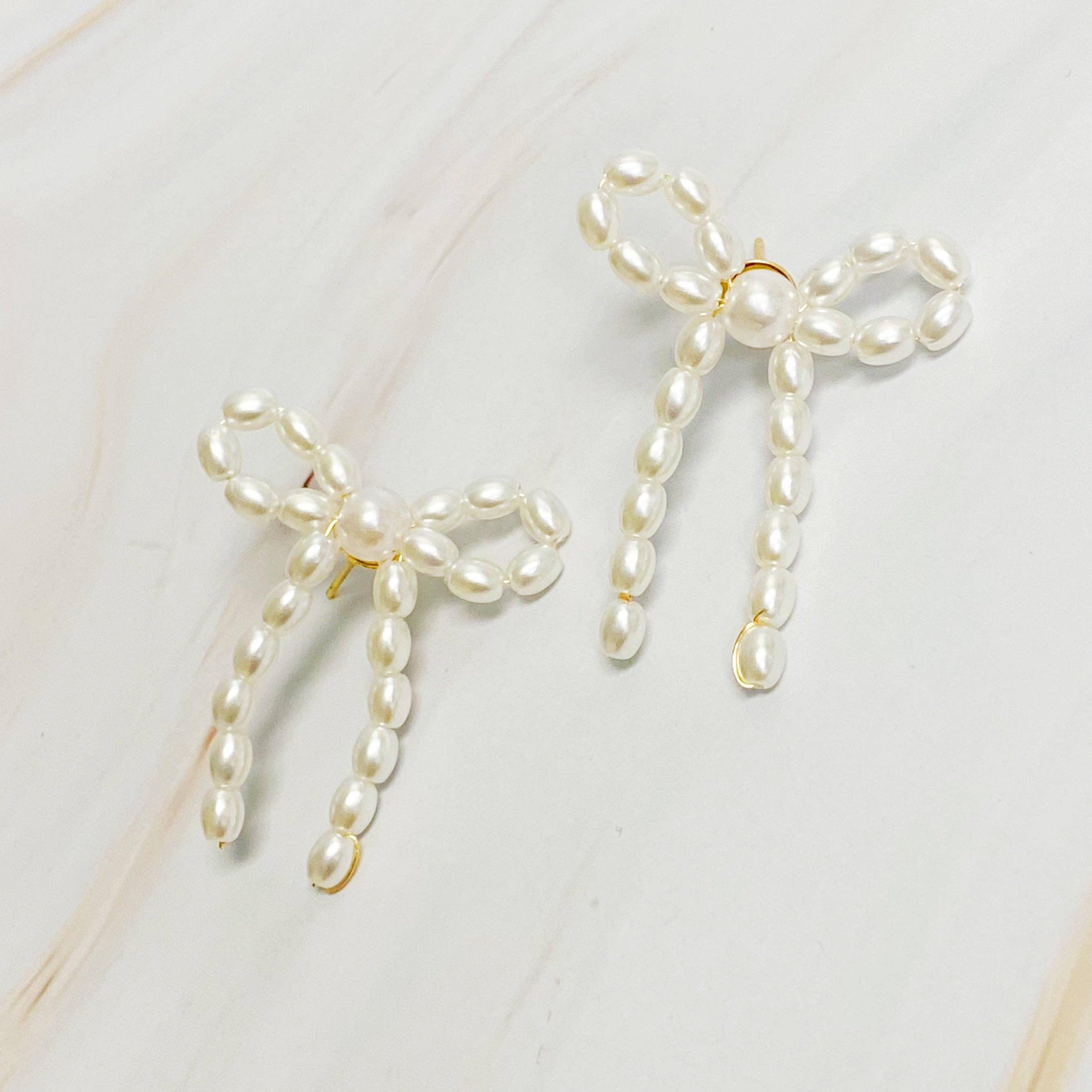 Pearl Bow Ballerina Earrings — color: cream white pearls with gold-tone posts and hand wired construction