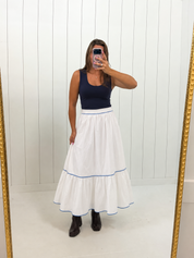 AI-styled preview of White & Blue Tiered Skirt on boutique owner