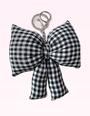 Ninety Nine Boutique super-pale pink accessory product photo: Black Checker Bow Bag Charm (September 30, 2026)