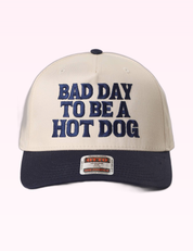 Ninety Nine Boutique super-pale pink accessory product photo: Navy Bad Day To Be A Hot Dog Trucker Hat (September 30, 2026)