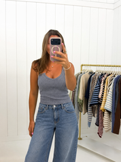 AI-assisted Gray Seamless Ribbed V-Neck Tank styling with vendor-reference hem placement, relaxed jeans and soft room lighting
