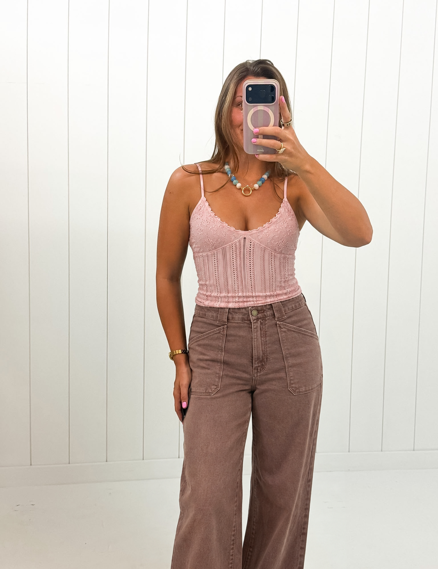 AI-styled Pink Jacquard Pattern Top on boutique owner with jeans and colorful necklace, approved corrected image September 21 2026