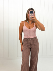 AI-styled Pink Jacquard Pattern Top on boutique owner with jeans and colorful necklace, approved corrected image September 21 2026