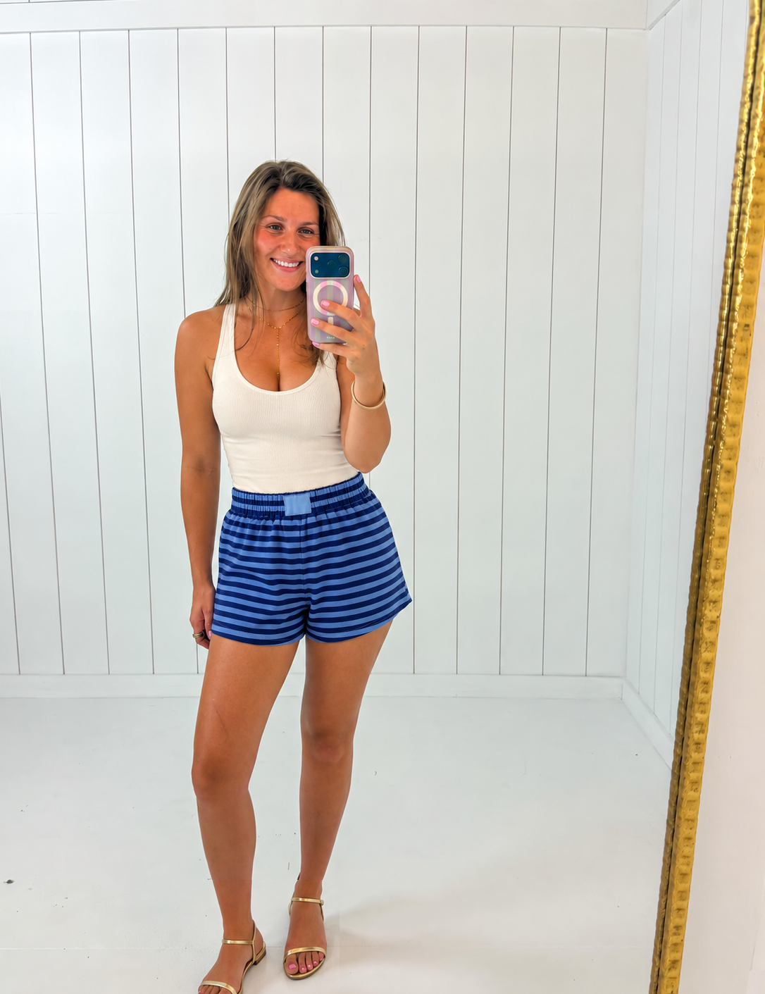 AI-assisted styled photo of Navy & Blue Striped Terry Shorts on boutique owner, soft original-room lighting approved September 21 2026