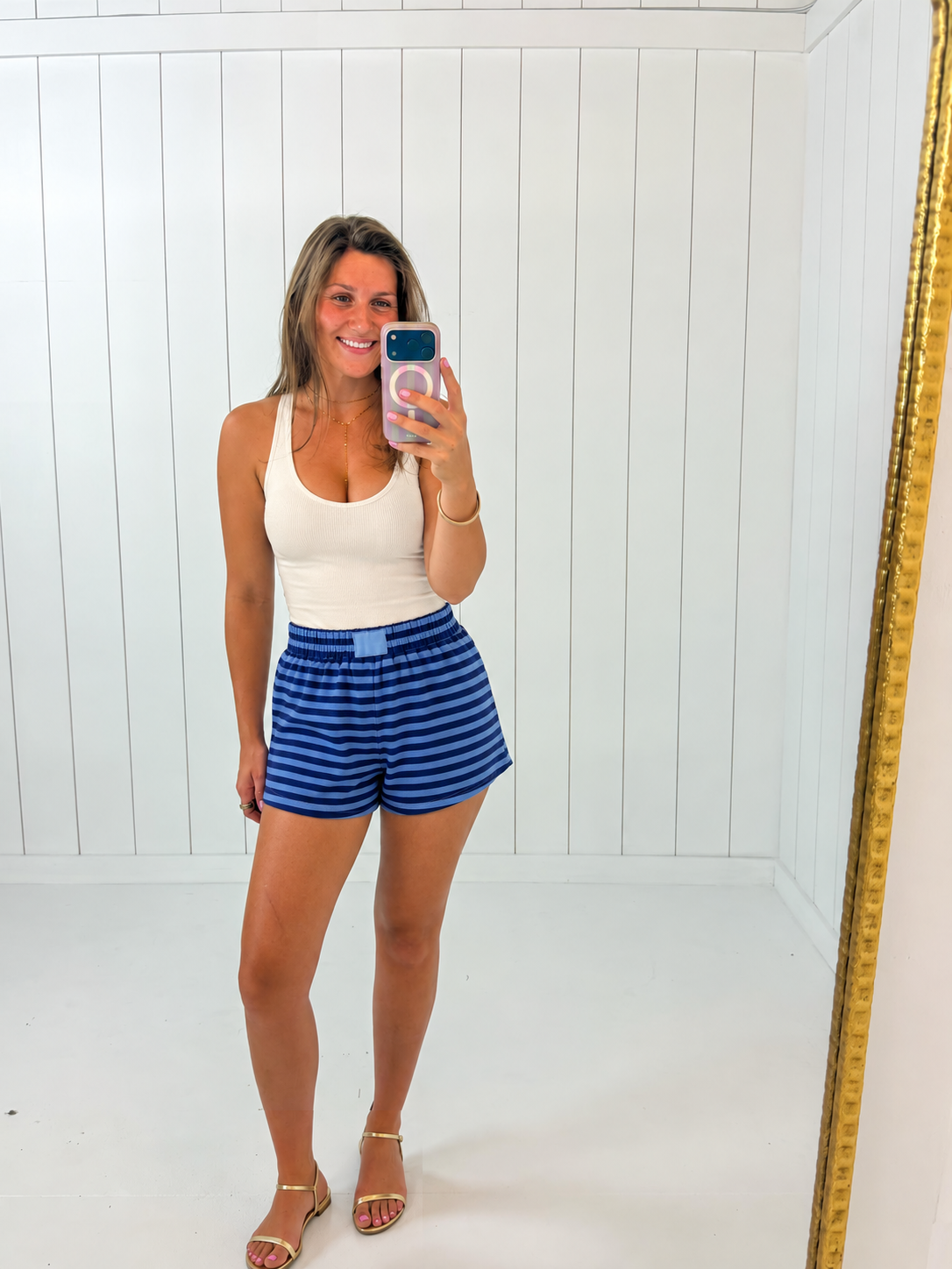 AI-assisted styled photo of Navy & Blue Striped Terry Shorts on boutique owner, soft original-room lighting approved September 21 2026