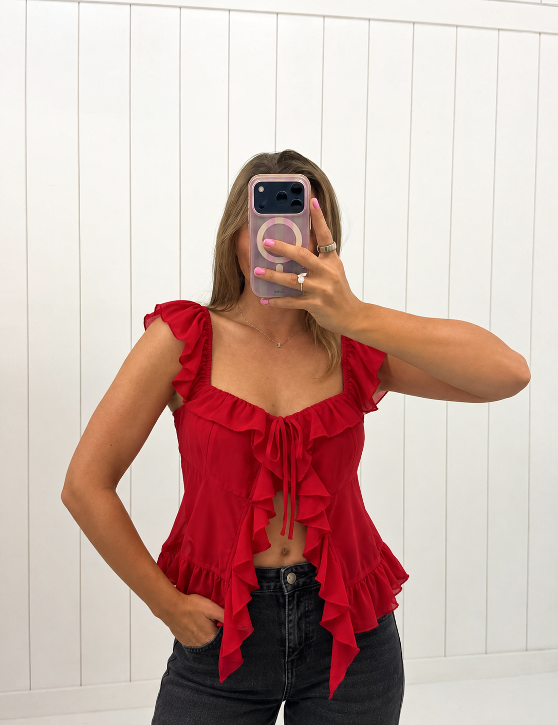 AI-assisted styled photo of Red Ruffle Detail Top on boutique owner, soft original-room lighting approved September 21 2026